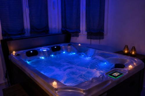 a jacuzzi tub with lights in a room at Eaux Spa in Rouen