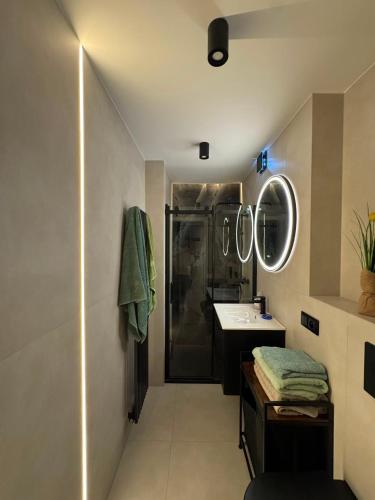 a bathroom with a shower and a sink and mirror at NOVA Apartament Podgórze in Wałbrzych