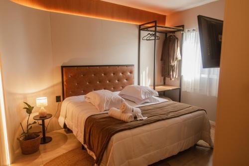 a bedroom with a bed with a teddy bear on it at Pousada e Restaurante Del Miro in Nova Pádua