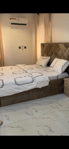a bedroom with a bed with a laptop on it at Oak Serviced Apartment-New Bodija in Ibadan