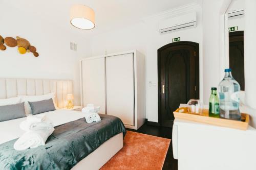 a bedroom with a bed and a desk with a mirror at Aparthotel QuintadaCostinha Alijó Douro in Alijó