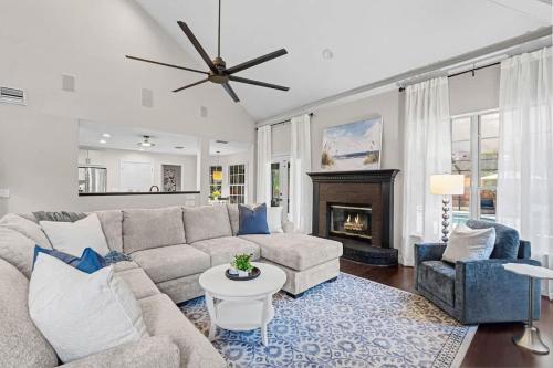 a living room with a couch and a fireplace at The Summer House - Private Pool Firepit in Jacksonville