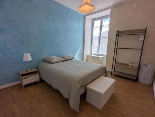 a bedroom with a large bed and a window at Appartement du parc in Ambert
