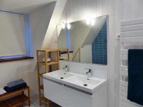 a bathroom with a white sink and a mirror at La Venise bleue in Colmar
