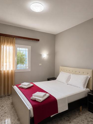 a bedroom with a large bed with towels on it at Vila New Ksamil in Ksamil