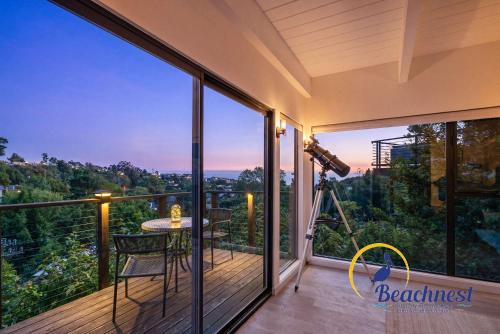 a view from the balcony of a house with a camera at Coastal Treehouse in Aptos