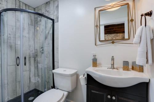 a bathroom with a toilet and a sink and a shower at Brick house in Savannah