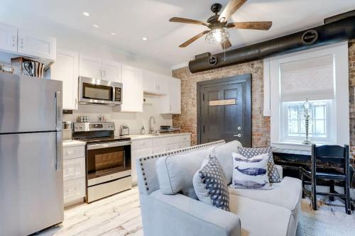 a kitchen and living room with a couch and a refrigerator at Brick house in Savannah