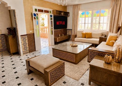 a living room with a couch and a table at Dar Joud in Gabès