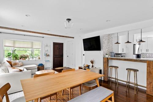 a kitchen and a living room with a wooden table at Cozy Greenport Cottage in Greenport
