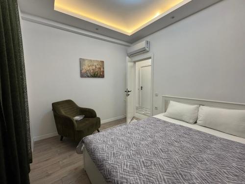 a bedroom with a bed and a chair in it at minta suits in Kemer
