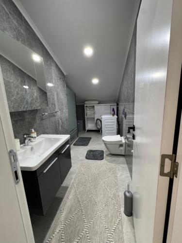 a bathroom with a sink and a toilet at minta suits in Kemer
