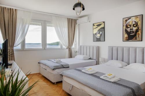 a hotel room with two beds and a window at Lala in Herceg-Novi
