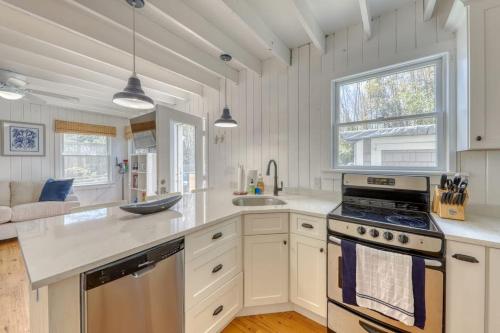 a kitchen with white cabinets and a stove top oven at The Surfcomber Multi-Residence Home in Ocean Bay Park