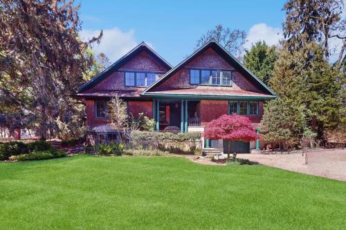 a house with a green lawn in front of it at Cedar Crest Retreat in Southampton