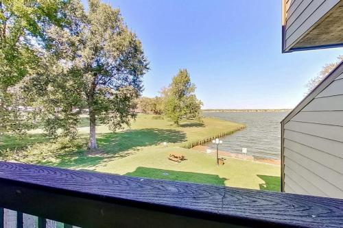 a view of a lake from a balcony of a house at Tranquility on the Lake in Montgomery