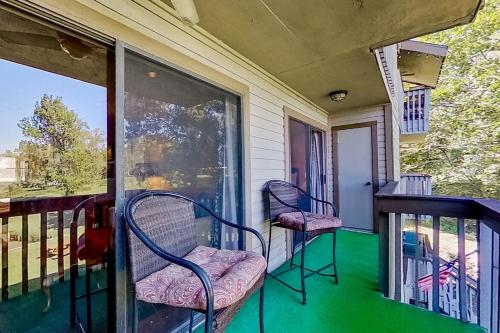 a screened porch with two chairs and a window at Tranquility on the Lake in Montgomery