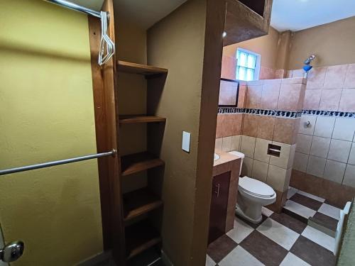 a small bathroom with a toilet and a sink at Casa Granada Jilotepec in Jilotepec