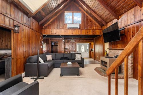 ein Wohnzimmer mit Sofa und Fernseher in der Unterkunft Tree Canopy Oasis in East Quogue