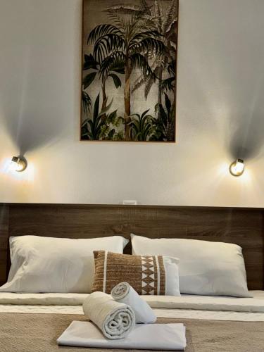 a bedroom with a bed with two white pillows at Avlή Apartments I in Kamári
