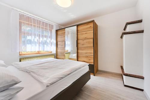 a bedroom with a large bed and a window at Luče Holiday Apartment in Luče