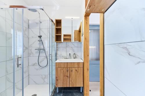 a bathroom with a sink and a shower at Luče Holiday Apartment in Luče