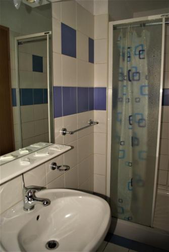 a bathroom with a sink and a shower at CT Tm in Timişoara