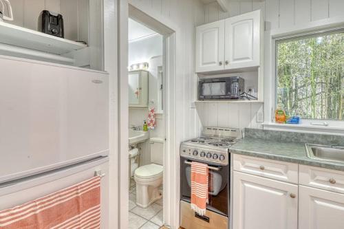 a kitchen with a stove and a sink and a toilet at The Surfcomber Unit 2 in Ocean Bay Park
