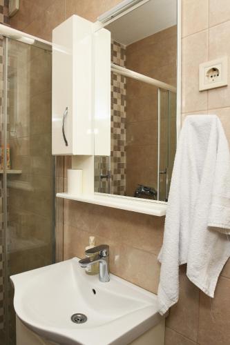 a bathroom with a sink and a mirror at Lala in Herceg-Novi