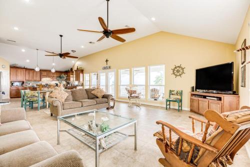 a large living room with a couch and a tv at Reel Paradise in Bacliff