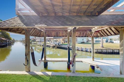 a wooden dock with aocked boats in the water at Waterfront Hideaway in La Marque