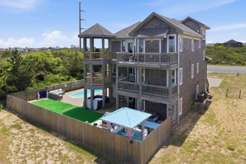 an aerial view of a house with a fence at 5471 - Resting Beach Face in Nags Head