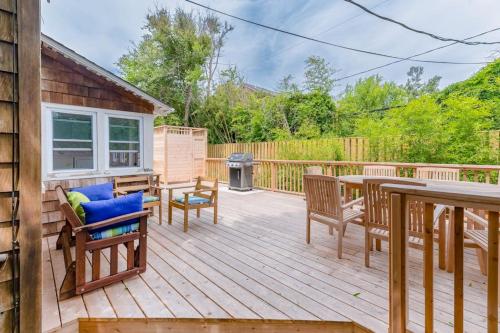 a deck with a table and chairs and a grill at Seaclusion Gardens in Ocean Beach