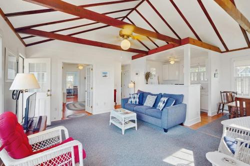 a living room with a blue couch and chairs at North Fork Waterfront Gem in East Marion