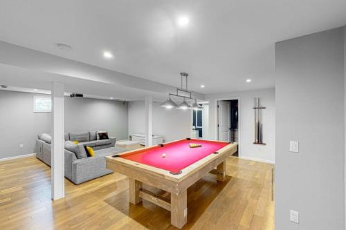 a living room with a pool table in it at Hamptons Hideaway in Hampton Bays