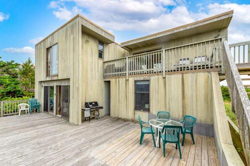 a wooden deck with a table and chairs at Robbins Rest Retreat in Ocean Beach