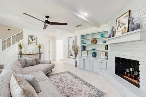 a living room with a couch and a fireplace at Lake Grove Retreat in Conroe