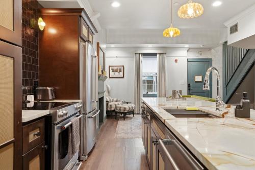 a kitchen with a sink and a stove at The Gas Lamp Hotel in Philadelphia
