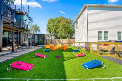 a yard with colorful trampolines on the grass at Blueberry Container at EADO Juicebox in Houston