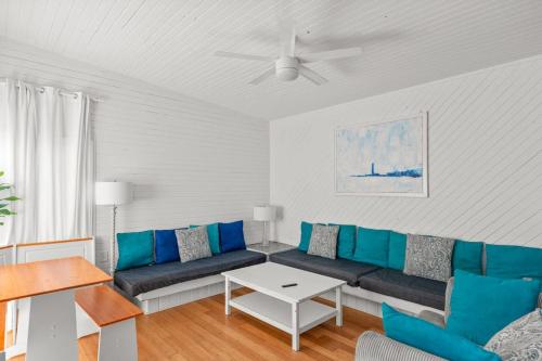 a living room with a blue couch and a table at 10 Cayuga in Ocean Bay Park