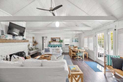 a living room with white furniture and a fireplace at 15 Seneca in Ocean Bay Park