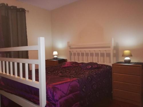 a bedroom with a white bed and two night stands at Casa do Pico in Câmara de Lobos