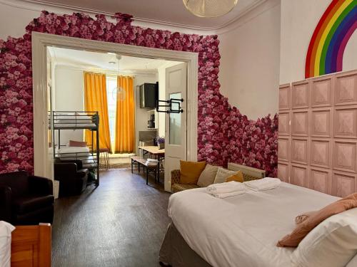 a bedroom with a rainbow painted on the wall at Hangover Hotel - Seafront 8 in Brighton & Hove