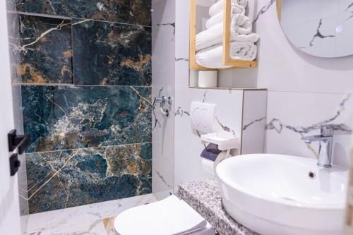 a bathroom with a sink and a toilet at Vila Goxhaj in Sarandë