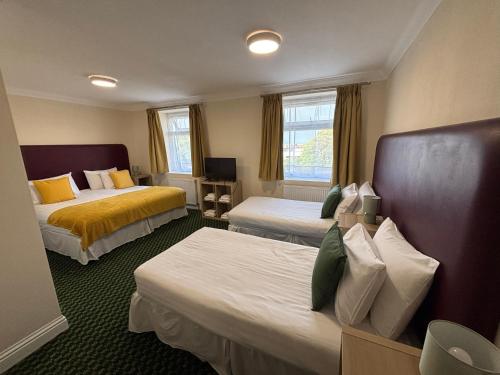 a hotel room with two beds in a room at Granby Hotel in Gravesend