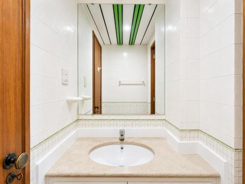 a bathroom with a sink and a mirror at Marina Plaza by Garvetur in Vilamoura