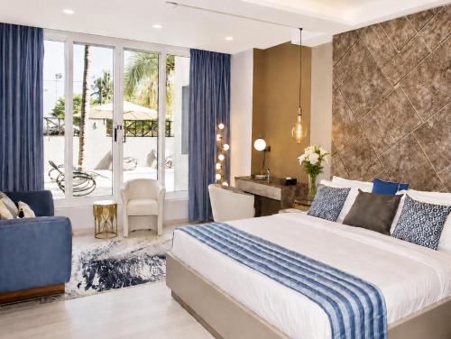 a bedroom with a large bed and a living room at THE POOL LABONE in Accra
