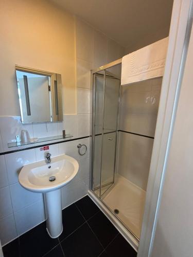 a bathroom with a sink and a shower at Granby Hotel in Gravesend