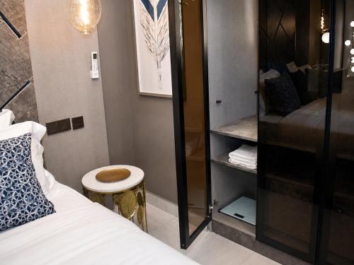 a small room with a bed and a toilet at THE POOL LABONE in Accra
