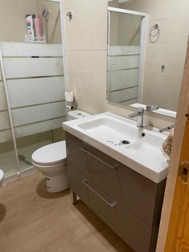 a bathroom with a sink and a toilet and a mirror at Mi Cielo in Cartagena